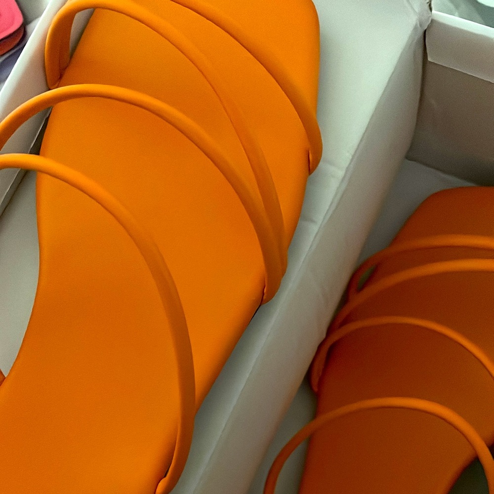 Those are orange flat slippers which are not used they turned out to be tight